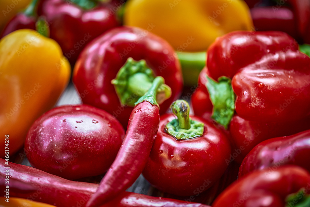 Colorful peppers background on the wooden background Colorful peppers background on the wooden background