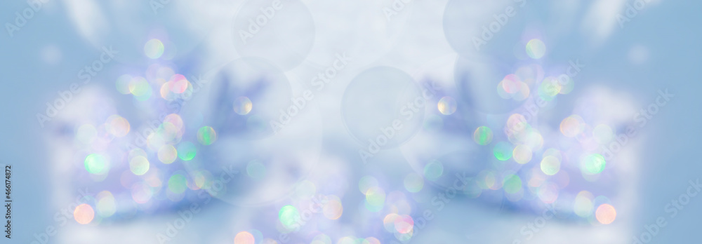 Abstract blurred bokeh background. Festive background for Christmas, New Year with a copy of the space in pastel blue tones