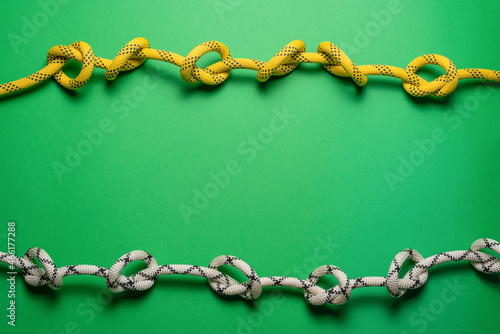 Climbing rope on the green flat lay background with copy space. © Natali