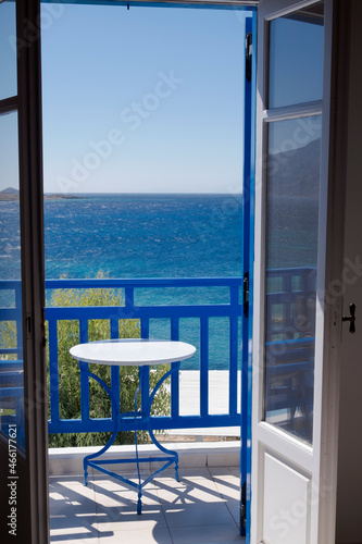 View through the window of the Aegean sea and blue balcony railings typical in Greece.  Photo taken in Koufonisia island  © tella0303