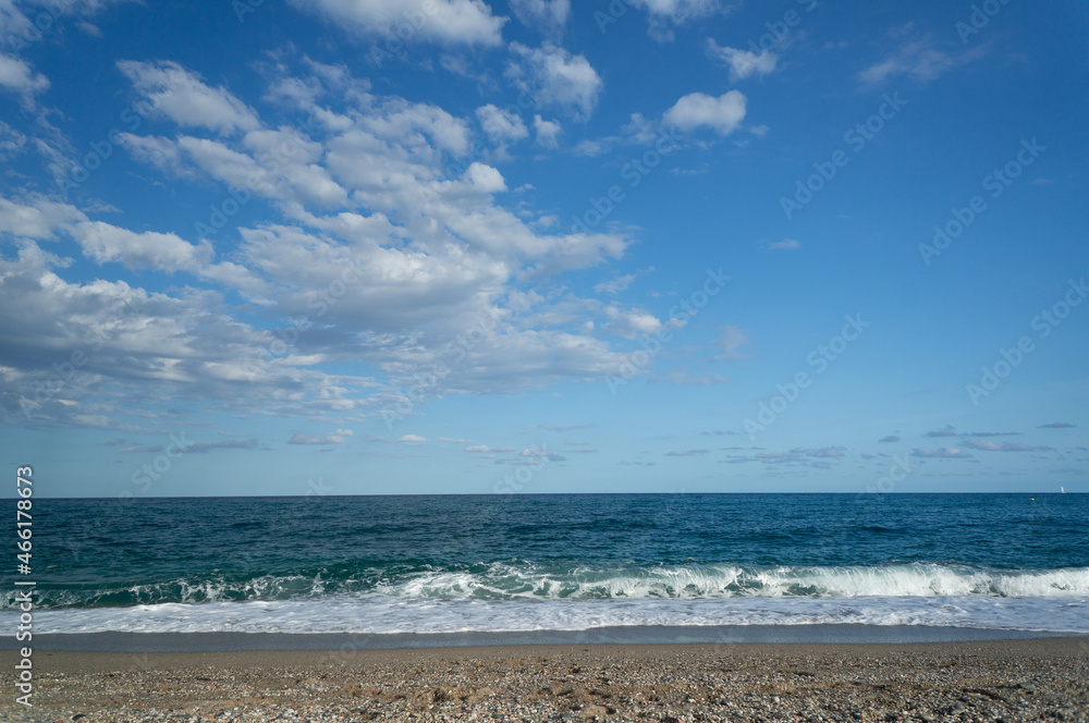summer day at a beach. view of the sea with waves at a sunny day