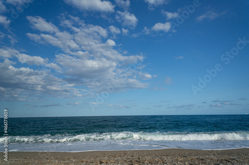 summer day at a beach. view of the sea with waves at a sunny day