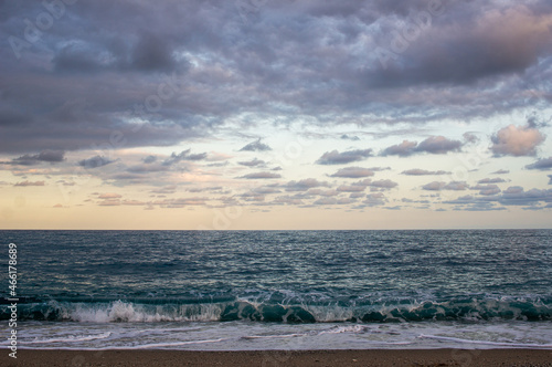 sea. waves at beach small clouds at sunset. horizontal