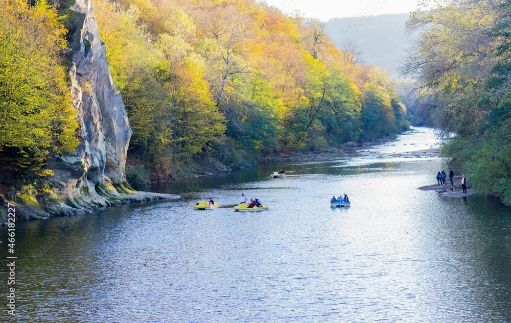 Landscape view of mountain river and colorful trees from bridge in autumn