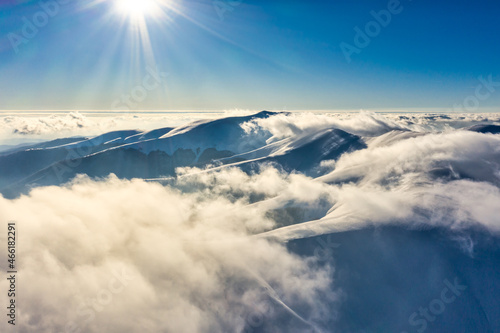 Flight through evening sky with clouds over mountain