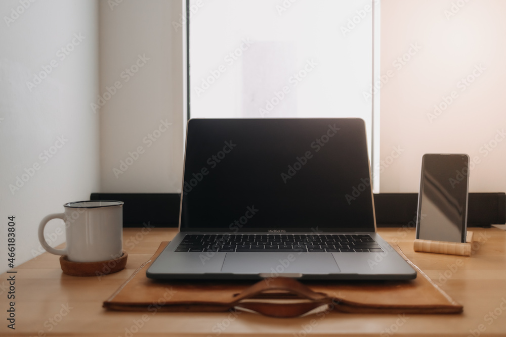 Laptop workspace on wooden desk by the windows with morning light. Laptop workspace on wooden desk by the windows with morning light.