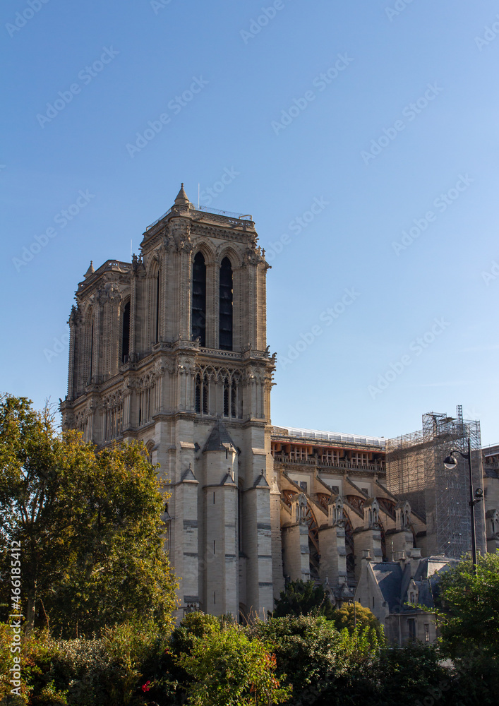 Cityscape view of the exterior stone architecture of the famous Notre Dame de Paris, including current reconstruction