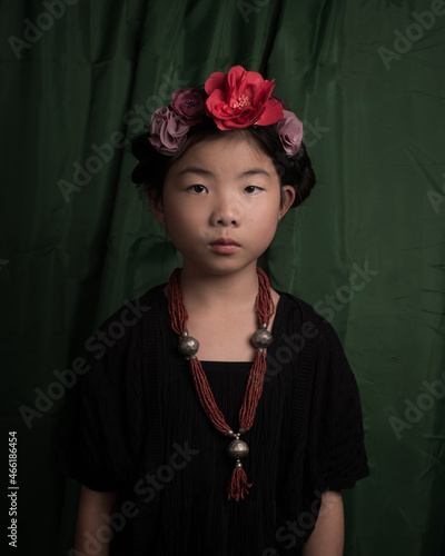 Fine art studio portrait of asian girl in Frida Kahlo style
