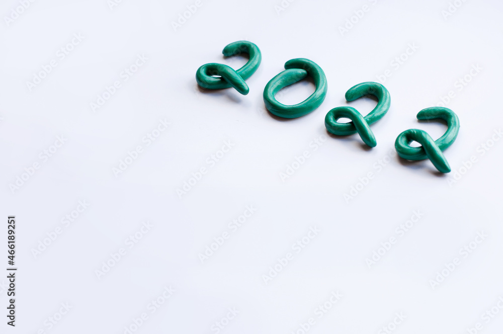 the numbers 2022 are made of green plasticine on a white background, written diagonally with space for text and blurred edges the numbers 2022 are made of green plasticine on a white background, written diagonally with space for text and blurred edges