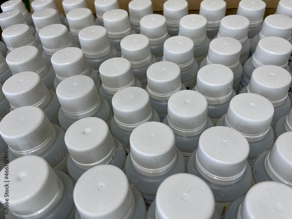 picture full of white plastic caps with their cans, sorted. close up. and different views picture full of white plastic caps with their cans, sorted. close up. and different views