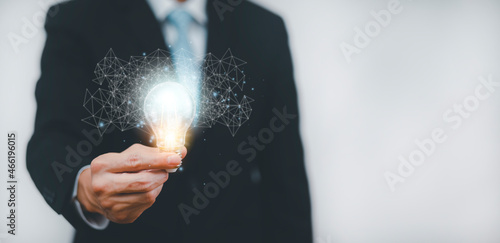 Double exposure of business hand holding light bulb with line connect and working on desk, Creativity and innovation are keys to success.Concept of new idea and innovation with energy and power.