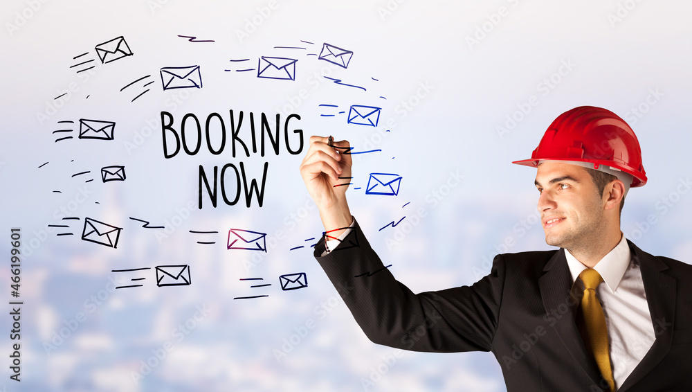 Young businessman with helmet drawing sale sign Young businessman with helmet drawing sale sign