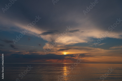 sunset in the sea with clouds and calm water