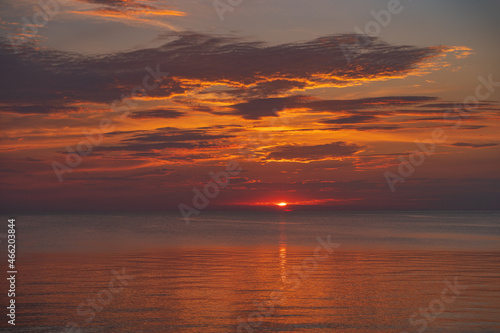sunset in the sea with clouds and calm water © gatis_photo