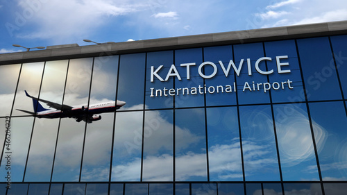 Airplane landing at Katowice Poland airport mirrored in terminal