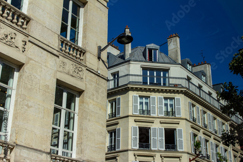 Close  upward exterior view of traditional building architecture in France  with stone walls and beautiful ornate French balconettes