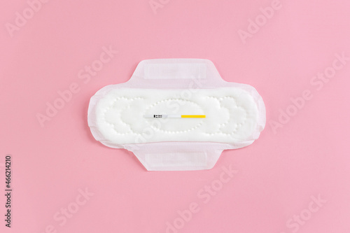 Сlean feminine sanitary napkin with an unused express FSH test. The minimum concept of the absence of menstruation in a woman. Copy space photo