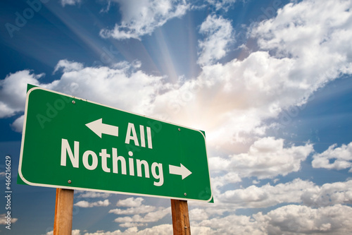 All or Nothing Green Road Sign Over Dramatic Clouds and Sky.