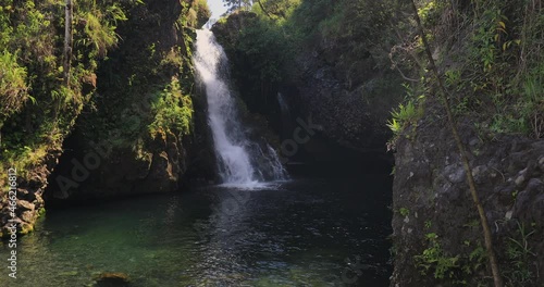 right to left panning motion of the Hanawi Falls or sometimes known as Upper Hanawi Falls which is a popular stop while travellers are driving on The Road to Hana, Maui, Hawaii, USA photo