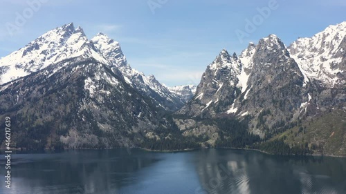 rising aerial drone shot of grand tetons in jackson wyoming during the summer photo
