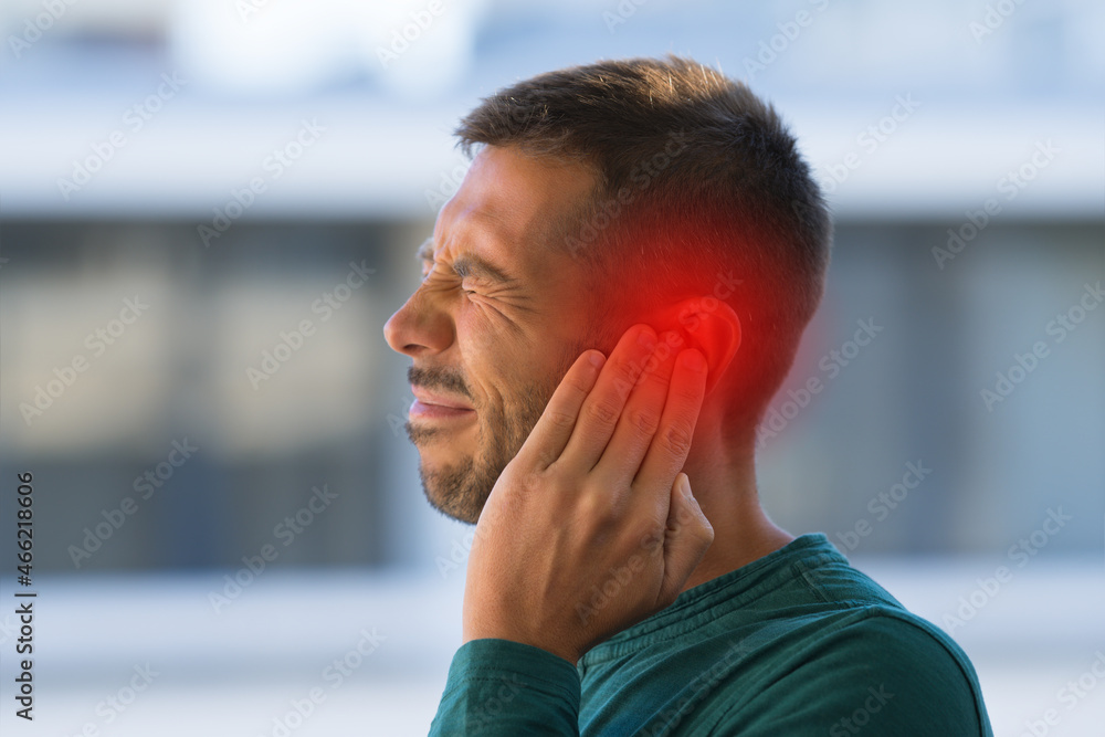 Fototapeta premium Man suffering from of strong earache or ear pain. Otitis