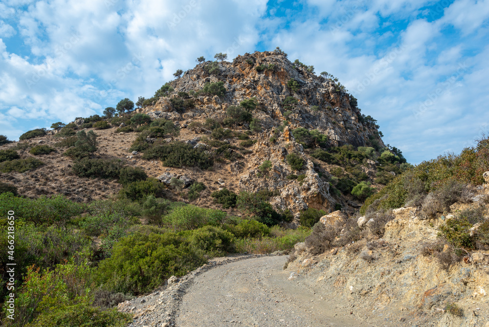 Conical hill on the hiking trail down from Pitsidia to Matala. The huge rock is a landmark, isolated and the only one in this part of Crete. The geological formation looks like a volcanic plug