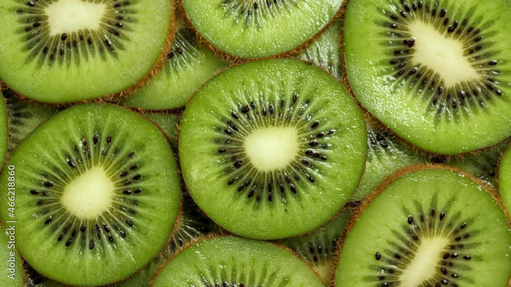 A lot of sliced Kiwi rotating. Ripe Tropical fruits closeup A lot of sliced Kiwi rotating. Ripe Tropical fruits closeup