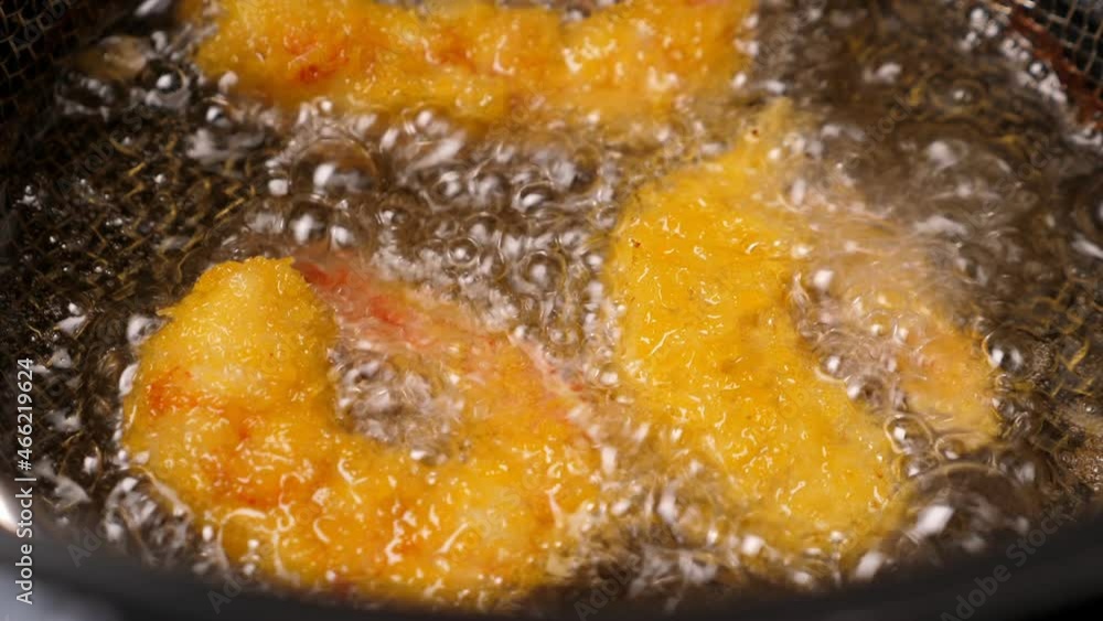 Cooking tempura shrimps in deep fryer. Closeup Cooking tempura shrimps in deep fryer. Closeup