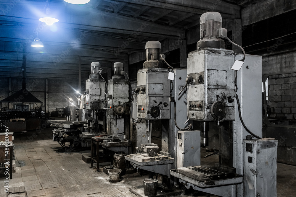 Old vertical milling machines equipment with flanged electric motors for metal processing in the workshop of the industrial plant Old vertical milling machines equipment with flanged electric motors for metal processing in the workshop of the industrial plant