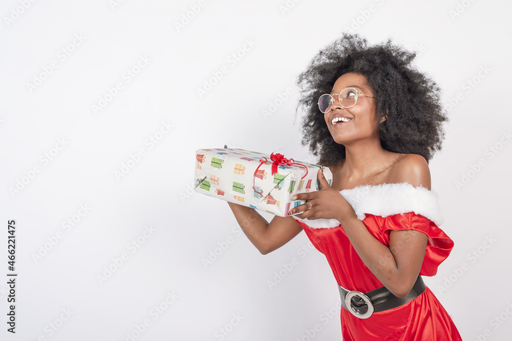 happy young woman giving a christmas present in a red costume happy young woman giving a christmas present in a red costume