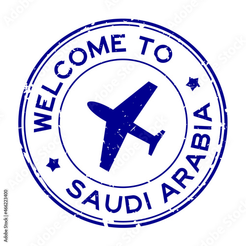 Grunge blue welcome to Saudi Arabia word with airplane icon round rubber seal stamp on white background