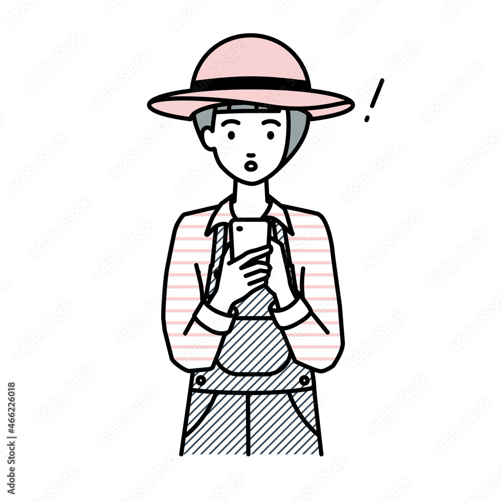 立ってスマートフォンを操作して何かに気づいて驚いた農家の女性 立ってスマートフォンを操作して何かに気づいて驚いた農家の女性