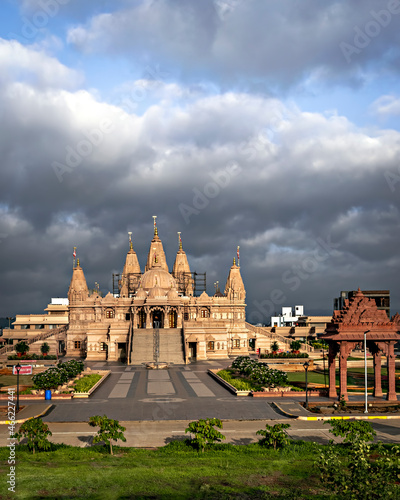 Crowdless Swaminarayan temple on a clear sunny day with clouds background in Ambegaon, Pune, Maharashtra, India. photo