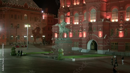 Moscow, Russia - 18 August 2018: People walk near monument to Georgy Zhukov near Historical Museum on Red Square of Moscow near walls of Kremlin on background of black sky at night .