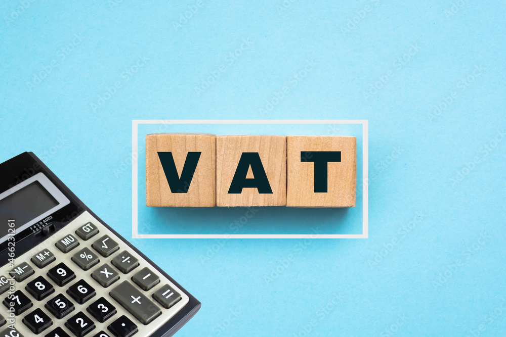 VAT inscription on wooden cubes on blue background VAT inscription on wooden cubes on blue background