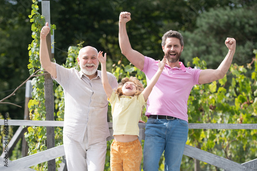 Excited grandfather father and son outdoors. Three men generation. Happy men family.