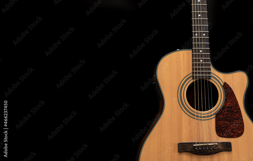 Acoustic guitar on a black background, flat lay, copy space.