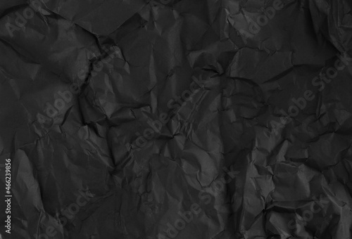 Fotografie Black crumpled wrinkled paper pattern surface texture background.