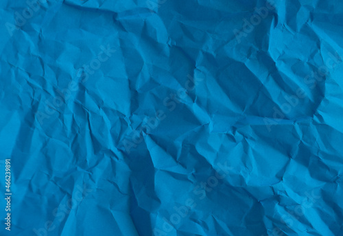 Blue crumpled wrinkled paper pattern surface texture background.