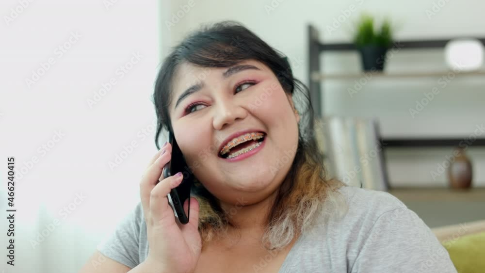 Body positive plus size woman holding mobile phone taking selfie photo using smartphone camera. Body positive plus size female lives happily and is proud of herself. Body positive plus size woman holding mobile phone taking selfie photo using smartphone camera. Body positive plus size female lives happily and is proud of herself.