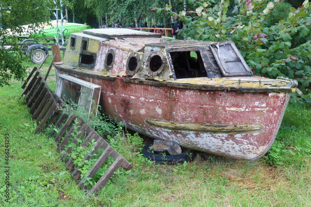 Old wooden fishing boat rots on the shore Old wooden fishing boat rots on the shore