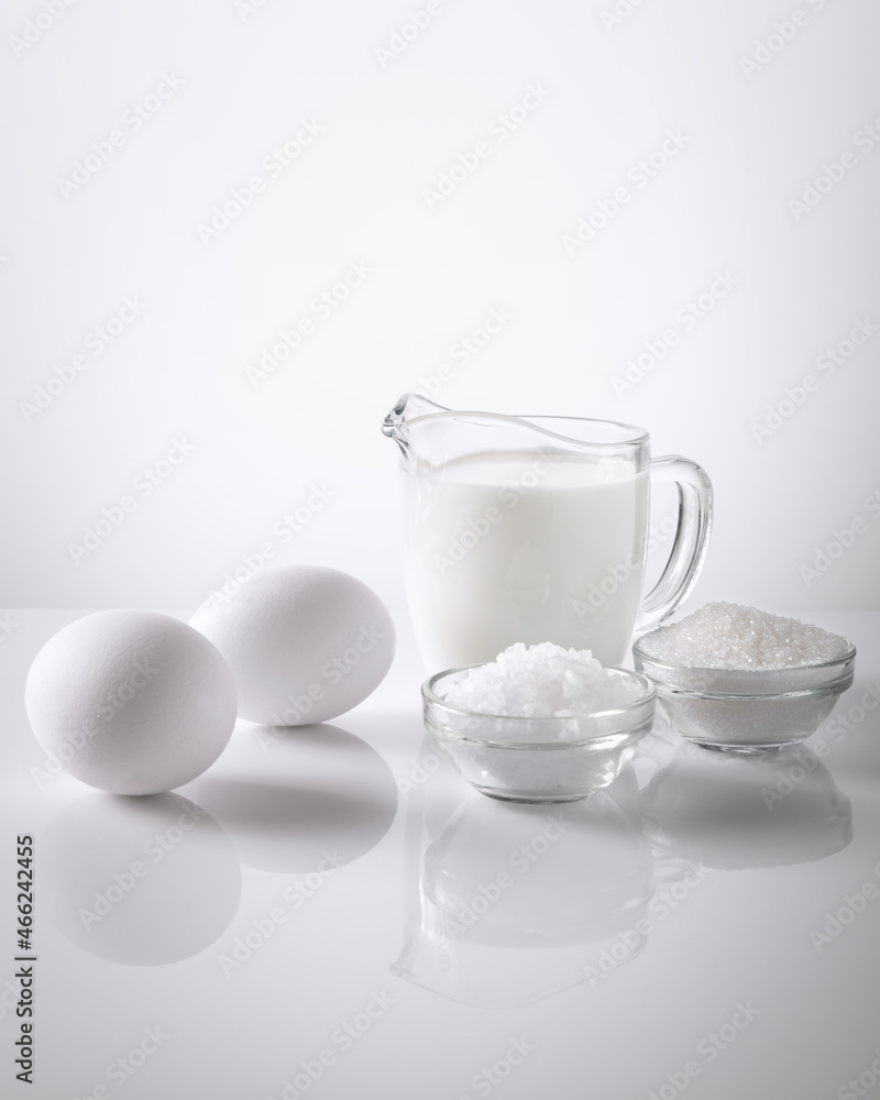 milk, salt, sugar, egg on a white background milk, salt, sugar, egg on a white background