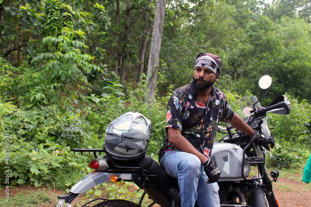 Handsome rider guy with beard and mustache in black printed shirt sit on racer motorcycle. Handsome rider guy with beard and mustache in black printed shirt sit on racer motorcycle.