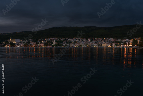Croatian coast town Selce illuminated at dusk.