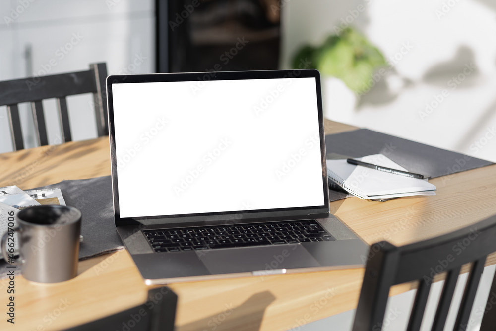 Fototapeta premium Laptop computer with blank screen on desktop in home office