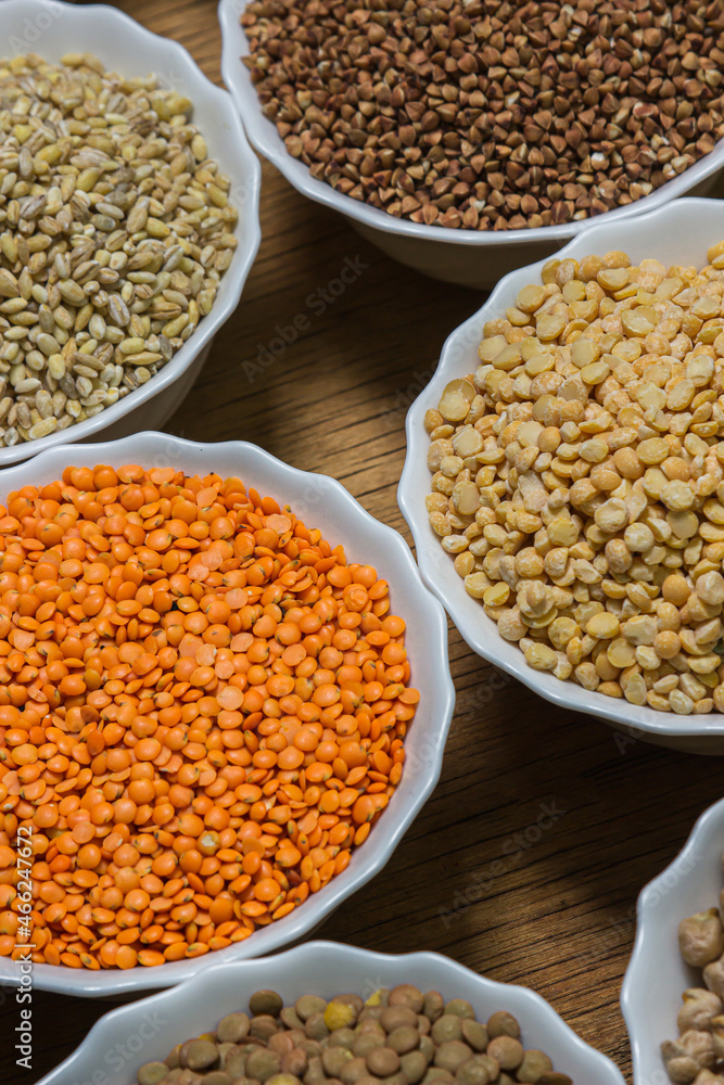 Various cereals on a wooden background. The concept of wholesome food. Vegetarian food