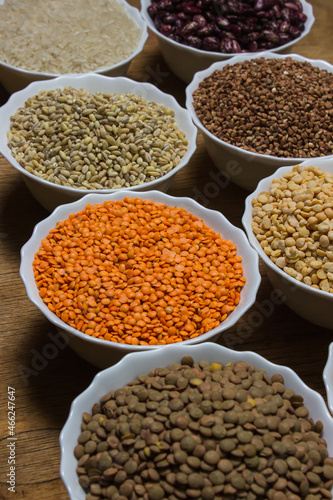 Various cereals on a wooden background. The concept of wholesome food. Vegetarian food