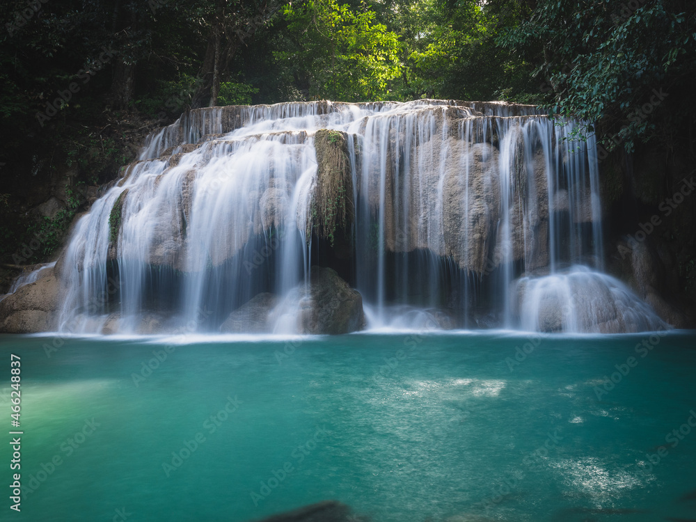 Fototapeta premium Scenic view of Erawan Waterfall breathtaking smooth flowing water stream with crystal clear turquoise lagoon in lush rainforest. Kanchanaburi, Thailand. Long exposure.