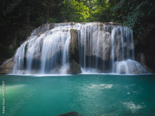 Scenic view of Erawan Waterfall breathtaking smooth flowing water stream with crystal clear turquoise lagoon in lush rainforest. Kanchanaburi  Thailand. Long exposure.