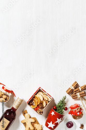 Mulled wine Ingredients as diy gift box, handmade present with dried fruits, honey, spices, christmas cookies. Red wine and red cup for christmas holiday hot winter drink